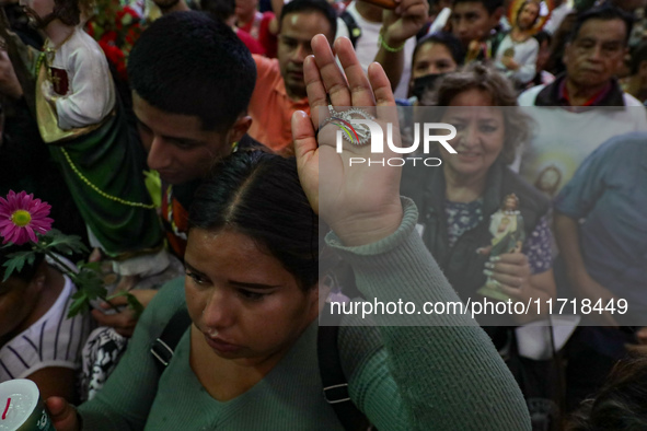 A devotee of Saint Jude Thaddeus attends the Church of San Hipolito to bless the images and give thanks for the favors granted in Mexico Cit...