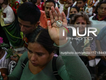 A devotee of Saint Jude Thaddeus attends the Church of San Hipolito to bless the images and give thanks for the favors granted in Mexico Cit...