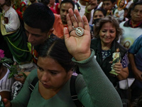 A devotee of Saint Jude Thaddeus attends the Church of San Hipolito to bless the images and give thanks for the favors granted in Mexico Cit...