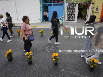 People attend to see decorations at Santa Cecilia Tlahuac in Mexico City, Mexico, on October 28, 2024, on the eve of Day of the Dead. (