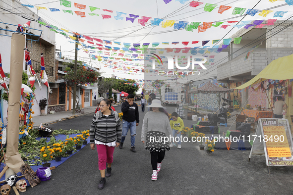 People attend to see decorations at Santa Cecilia Tlahuac in Mexico City, Mexico, on October 28, 2024, on the eve of Day of the Dead. 