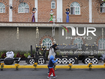 People attend to see decorations at Santa Cecilia Tlahuac in Mexico City, Mexico, on October 28, 2024, on the eve of Day of the Dead. (