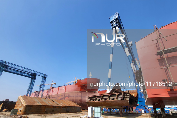 Workers produce ship hulls at Tuangang Community Shipbuilding base in Yanweigang town, Guanyun County, Lianyungang, China, on October 29, 20...