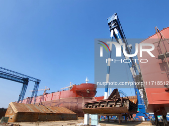 Workers produce ship hulls at Tuangang Community Shipbuilding base in Yanweigang town, Guanyun County, Lianyungang, China, on October 29, 20...