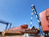 Workers produce ship hulls at Tuangang Community Shipbuilding base in Yanweigang town, Guanyun County, Lianyungang, China, on October 29, 20...