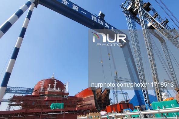 Workers produce ship hulls at Tuangang Community Shipbuilding base in Yanweigang town, Guanyun County, Lianyungang, China, on October 29, 20...