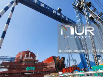 Workers produce ship hulls at Tuangang Community Shipbuilding base in Yanweigang town, Guanyun County, Lianyungang, China, on October 29, 20...