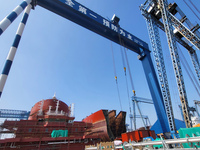 Workers produce ship hulls at Tuangang Community Shipbuilding base in Yanweigang town, Guanyun County, Lianyungang, China, on October 29, 20...