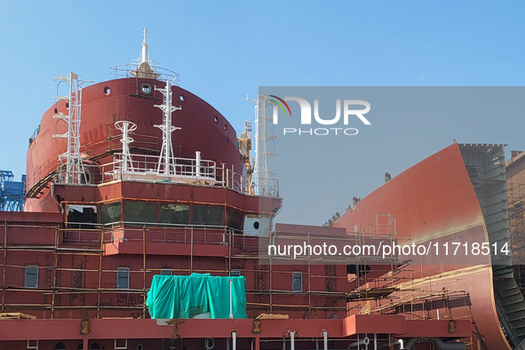 Workers produce ship hulls at Tuangang Community Shipbuilding base in Yanweigang town, Guanyun County, Lianyungang, China, on October 29, 20...