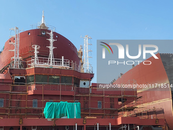 Workers produce ship hulls at Tuangang Community Shipbuilding base in Yanweigang town, Guanyun County, Lianyungang, China, on October 29, 20...