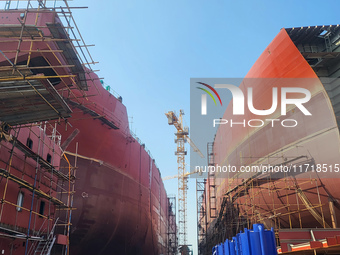 Workers produce ship hulls at Tuangang Community Shipbuilding base in Yanweigang town, Guanyun County, Lianyungang, China, on October 29, 20...