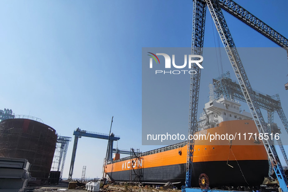 Workers produce ship hulls at Tuangang Community Shipbuilding base in Yanweigang town, Guanyun County, Lianyungang, China, on October 29, 20...