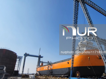 Workers produce ship hulls at Tuangang Community Shipbuilding base in Yanweigang town, Guanyun County, Lianyungang, China, on October 29, 20...