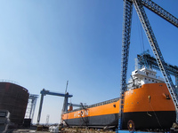 Workers produce ship hulls at Tuangang Community Shipbuilding base in Yanweigang town, Guanyun County, Lianyungang, China, on October 29, 20...