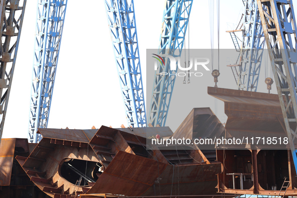 Workers produce ship hulls at Tuangang Community Shipbuilding base in Yanweigang town, Guanyun County, Lianyungang, China, on October 29, 20...