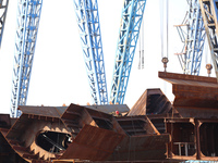 Workers produce ship hulls at Tuangang Community Shipbuilding base in Yanweigang town, Guanyun County, Lianyungang, China, on October 29, 20...