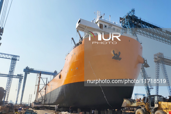 Workers produce ship hulls at Tuangang Community Shipbuilding base in Yanweigang town, Guanyun County, Lianyungang, China, on October 29, 20...