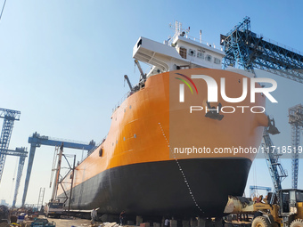 Workers produce ship hulls at Tuangang Community Shipbuilding base in Yanweigang town, Guanyun County, Lianyungang, China, on October 29, 20...