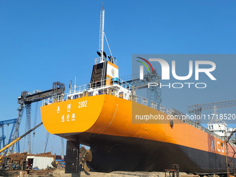 Workers produce ship hulls at Tuangang Community Shipbuilding base in Yanweigang town, Guanyun County, Lianyungang, China, on October 29, 20...