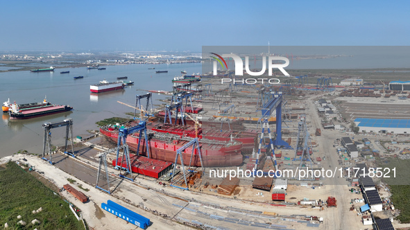 Workers produce ship hulls at Tuangang Community Shipbuilding base in Yanweigang town, Guanyun County, Lianyungang, China, on October 29, 20...