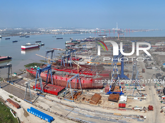 Workers produce ship hulls at Tuangang Community Shipbuilding base in Yanweigang town, Guanyun County, Lianyungang, China, on October 29, 20...