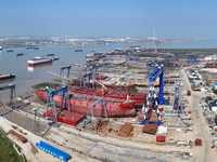 Workers produce ship hulls at Tuangang Community Shipbuilding base in Yanweigang town, Guanyun County, Lianyungang, China, on October 29, 20...