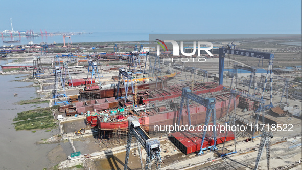 Workers produce ship hulls at Tuangang Community Shipbuilding base in Yanweigang town, Guanyun County, Lianyungang, China, on October 29, 20...