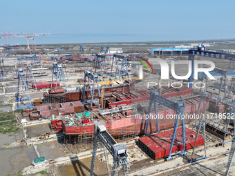 Workers produce ship hulls at Tuangang Community Shipbuilding base in Yanweigang town, Guanyun County, Lianyungang, China, on October 29, 20...