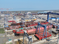 Workers produce ship hulls at Tuangang Community Shipbuilding base in Yanweigang town, Guanyun County, Lianyungang, China, on October 29, 20...