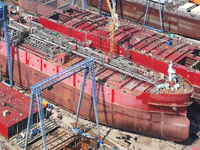 Workers produce ship hulls at Tuangang Community Shipbuilding base in Yanweigang town, Guanyun County, Lianyungang, China, on October 29, 20...