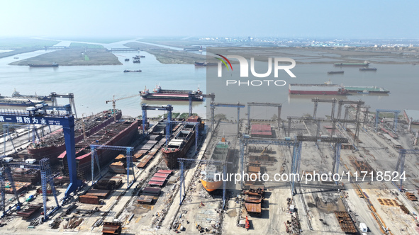 Workers produce ship hulls at Tuangang Community Shipbuilding base in Yanweigang town, Guanyun County, Lianyungang, China, on October 29, 20...