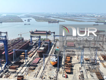 Workers produce ship hulls at Tuangang Community Shipbuilding base in Yanweigang town, Guanyun County, Lianyungang, China, on October 29, 20...