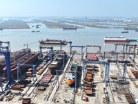 Workers produce ship hulls at Tuangang Community Shipbuilding base in Yanweigang town, Guanyun County, Lianyungang, China, on October 29, 20...