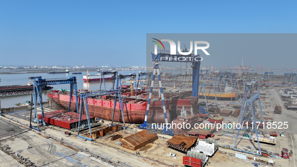 Workers produce ship hulls at Tuangang Community Shipbuilding base in Yanweigang town, Guanyun County, Lianyungang, China, on October 29, 20...