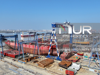 Workers produce ship hulls at Tuangang Community Shipbuilding base in Yanweigang town, Guanyun County, Lianyungang, China, on October 29, 20...