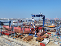 Workers produce ship hulls at Tuangang Community Shipbuilding base in Yanweigang town, Guanyun County, Lianyungang, China, on October 29, 20...