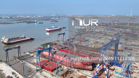 Workers produce ship hulls at Tuangang Community Shipbuilding base in Yanweigang town, Guanyun County, Lianyungang, China, on October 29, 20...