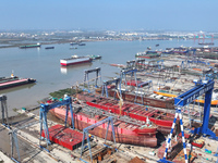 Workers produce ship hulls at Tuangang Community Shipbuilding base in Yanweigang town, Guanyun County, Lianyungang, China, on October 29, 20...