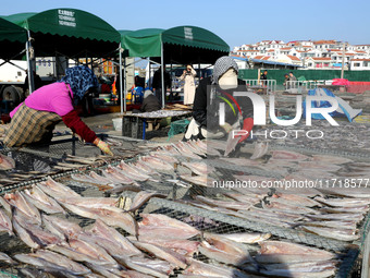 Fishermen dry fish at the fishing port of Xiliandao village in Lianyungang, China, on October 29, 2024. (