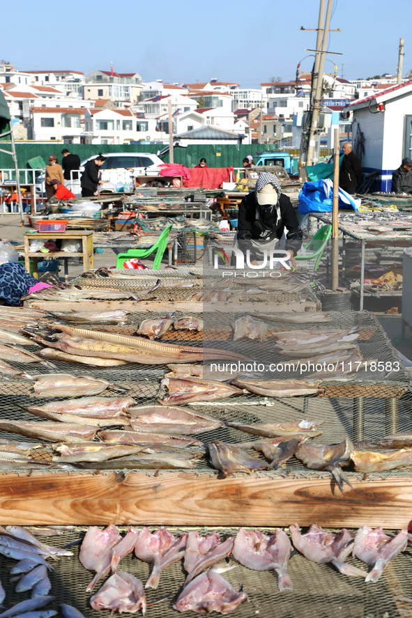 Fishermen dry fish at the fishing port of Xiliandao village in Lianyungang, China, on October 29, 2024. 