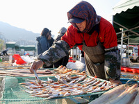 Fishermen dry fish at the fishing port of Xiliandao village in Lianyungang, China, on October 29, 2024. (