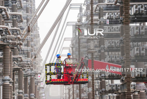 Power maintenance personnel overhaul the equipment of Guquan converter station in Xuancheng, China, on October 29, 2024. 