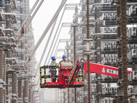 Power maintenance personnel overhaul the equipment of Guquan converter station in Xuancheng, China, on October 29, 2024. (