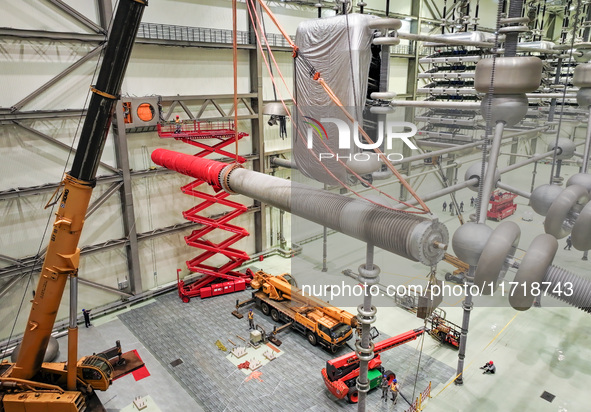 Power maintenance personnel overhaul the equipment of Guquan converter station in Xuancheng, China, on October 29, 2024. 