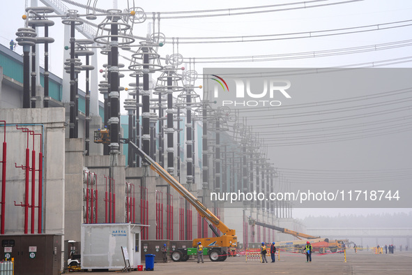 Power maintenance personnel overhaul the equipment of Guquan converter station in Xuancheng, China, on October 29, 2024. 