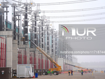 Power maintenance personnel overhaul the equipment of Guquan converter station in Xuancheng, China, on October 29, 2024. (