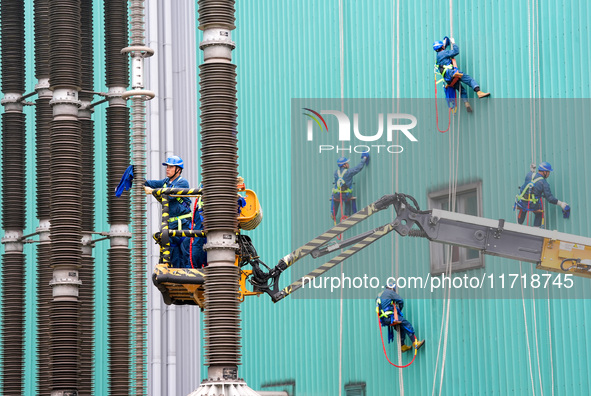 Power maintenance personnel overhaul the equipment of Guquan converter station in Xuancheng, China, on October 29, 2024. 