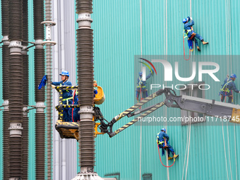 Power maintenance personnel overhaul the equipment of Guquan converter station in Xuancheng, China, on October 29, 2024. (