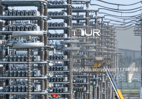 Power maintenance personnel overhaul the equipment of Guquan converter station in Xuancheng, China, on October 29, 2024. 