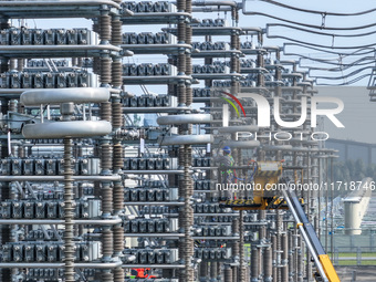 Power maintenance personnel overhaul the equipment of Guquan converter station in Xuancheng, China, on October 29, 2024. (